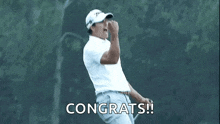 a man is shaking hands with another man on a golf course in the rain .