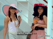 two women wearing hats and sunglasses are standing next to each other and one of them says hello hello ~ pisau cukur