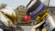 a statue of a bird with a red beak and a purple headband