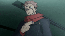 a man with a red scarf around his neck has purple nails