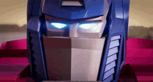 a close up of a robot 's head with blue eyes