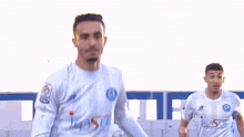 a soccer player wearing a white jersey that says i-sm