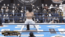 a wrestler in a ring with a crowd watching and a sign that says best of the super