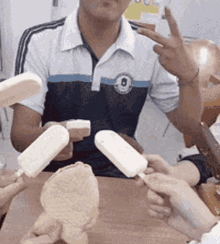 a man in a blue and white shirt is holding ice cream
