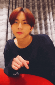 a young man with red hair is wearing a black shirt that says rvca on the sleeve