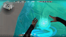 a person 's hands are reaching out towards a blue sphere in a video game .