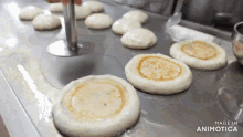 a bunch of pancakes are being cooked on a stove and the words made in animotica are visible