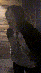 a blurry picture of a person standing in front of a wall