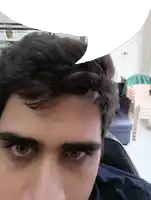 a close up of a man 's face with a speech bubble behind him