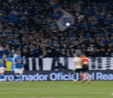 a soccer game is being played in front of a banner that says " cronador oficial del real "