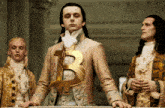 a man in a gold suit has a large gold b on his chest