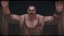 a man with blood on his shirt is standing in a doorway with his hands up