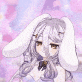 a girl with bunny ears is holding a yellow object in her hand