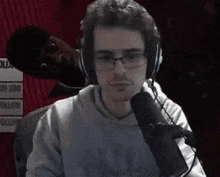 a man wearing headphones is talking into a microphone .