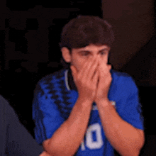 a man in a blue jersey with the number 10 on it