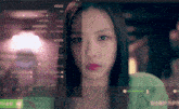 a close up of a woman 's face in front of a computer screen with chinese writing