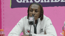 a man wearing a white sweatshirt with a nfl logo on it
