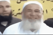 a man with a beard and a white hat is smiling