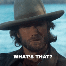 a man with a beard wearing a cowboy hat with the words what 's that below him