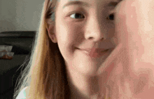 a close up of a girl 's face with a hand on her face