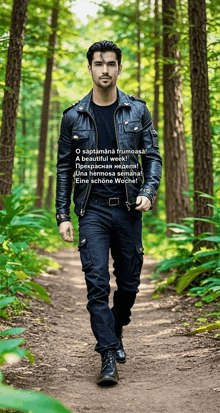 a man in a leather jacket walks through the woods