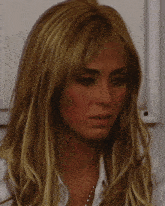 a close up of a woman 's face with a serious look on her face
