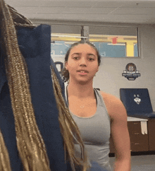 a woman stands in front of a sign that says ' ucsd football '
