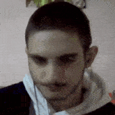 a man with a beard is wearing headphones and a black shirt