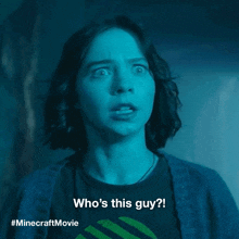 a woman with a surprised look on her face is wearing a minecraft movie shirt