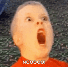 a close up of a child 's face with his mouth open and the words `` nooooo '' .