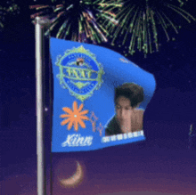 a blue flag with a picture of a man and the word kinn on it