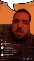 a man with glasses and a beard is sitting in a chair with a speech bubble above his head