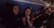 a group of people are sitting on a roller coaster at night .