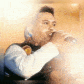 a man is singing into a microphone in a painting