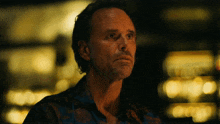 a close up of a man 's face with a blurry background that says coca-cola