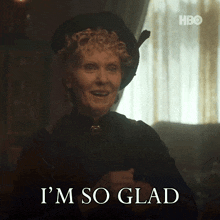 a woman says i 'm so glad while wearing a hat