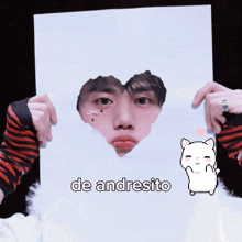 a person holding a piece of paper that says de andresito on it