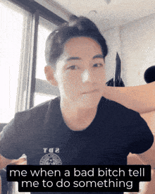 a man wearing a black shirt that says tq2 on it