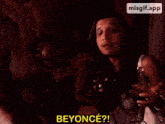 a woman is holding a wine glass and saying beyonce