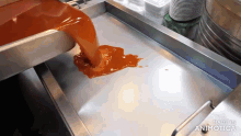 a sauce is being poured into a pan and the words made in animatica are on the bottom of the screen