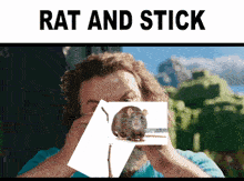 a man is holding a card with a picture of a rat on it under the words " rat and stick "