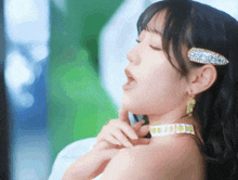 a close up of a woman 's face with a choker around her neck