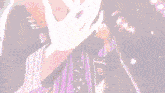 a close up of a person 's hand with a purple background