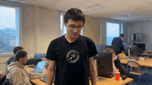 a man wearing a black t-shirt that says " programming club "