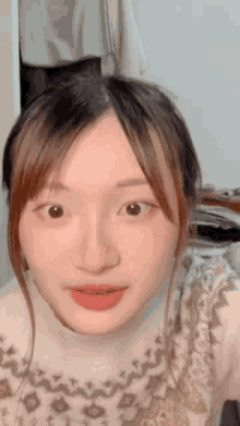 a close up of a woman 's face with her mouth open
