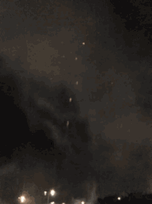 a large fireball is exploding in the dark sky