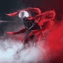 a person with red wings is flying through a red smokey area .