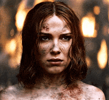 a close up of a woman 's face with a lot of blood on it