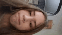 a close up of a girl 's face with a serious look on her face .