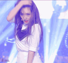a woman in a sailor uniform is dancing on a stage with the words " you are my the universe " in the corner
